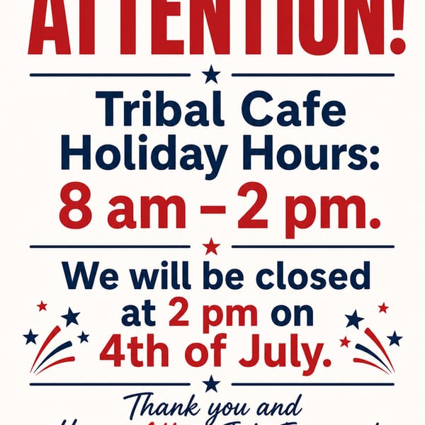 A sign for Tribal Cafe announcing holiday hours of 8 am - 2 pm, closing at 2 pm on July 4th.